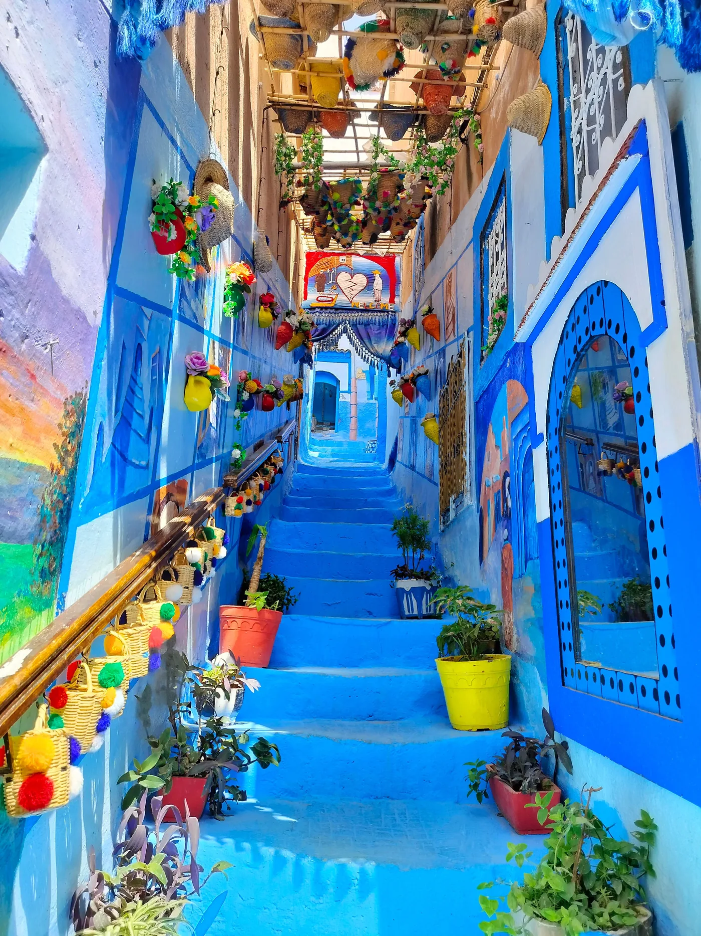 Vibrant blue alley with colorful decorations in Morocco