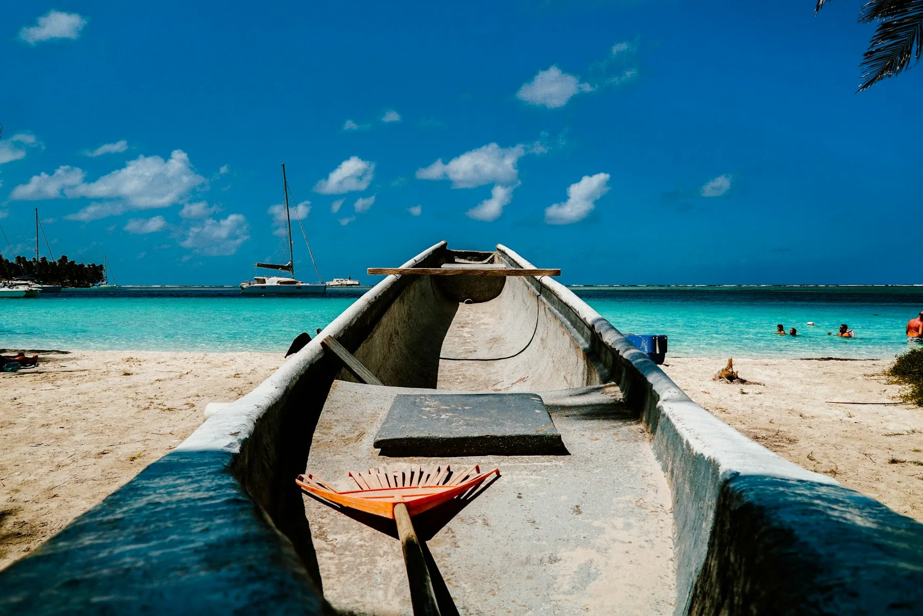 Wooden boat resting on a bright tropical beach