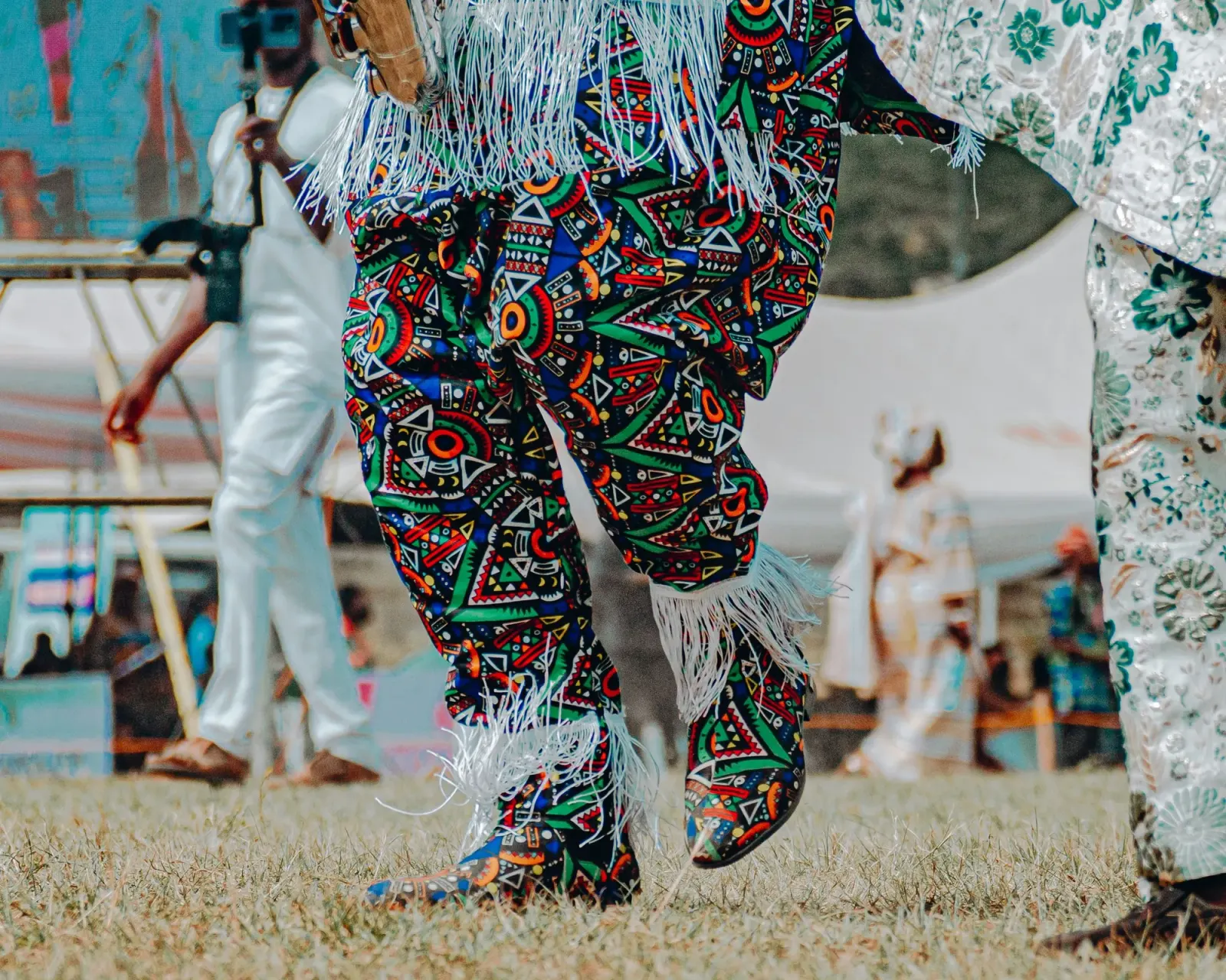 A colorful masquerade dancer at a festival