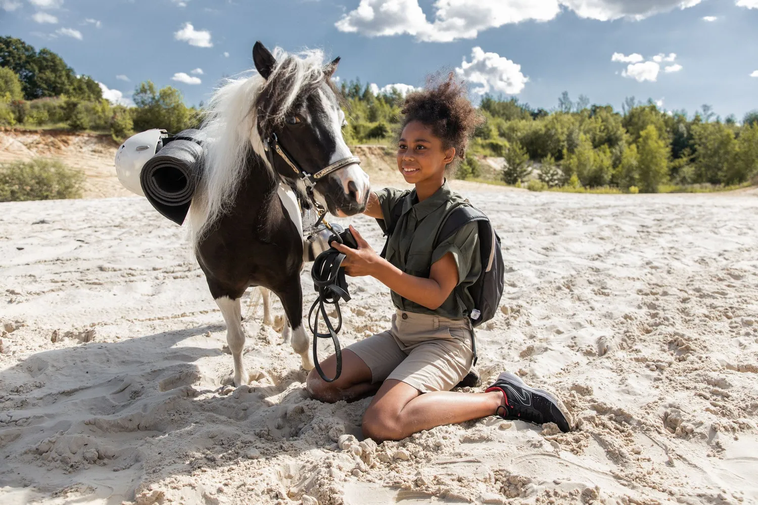 A child with a pony on the beach