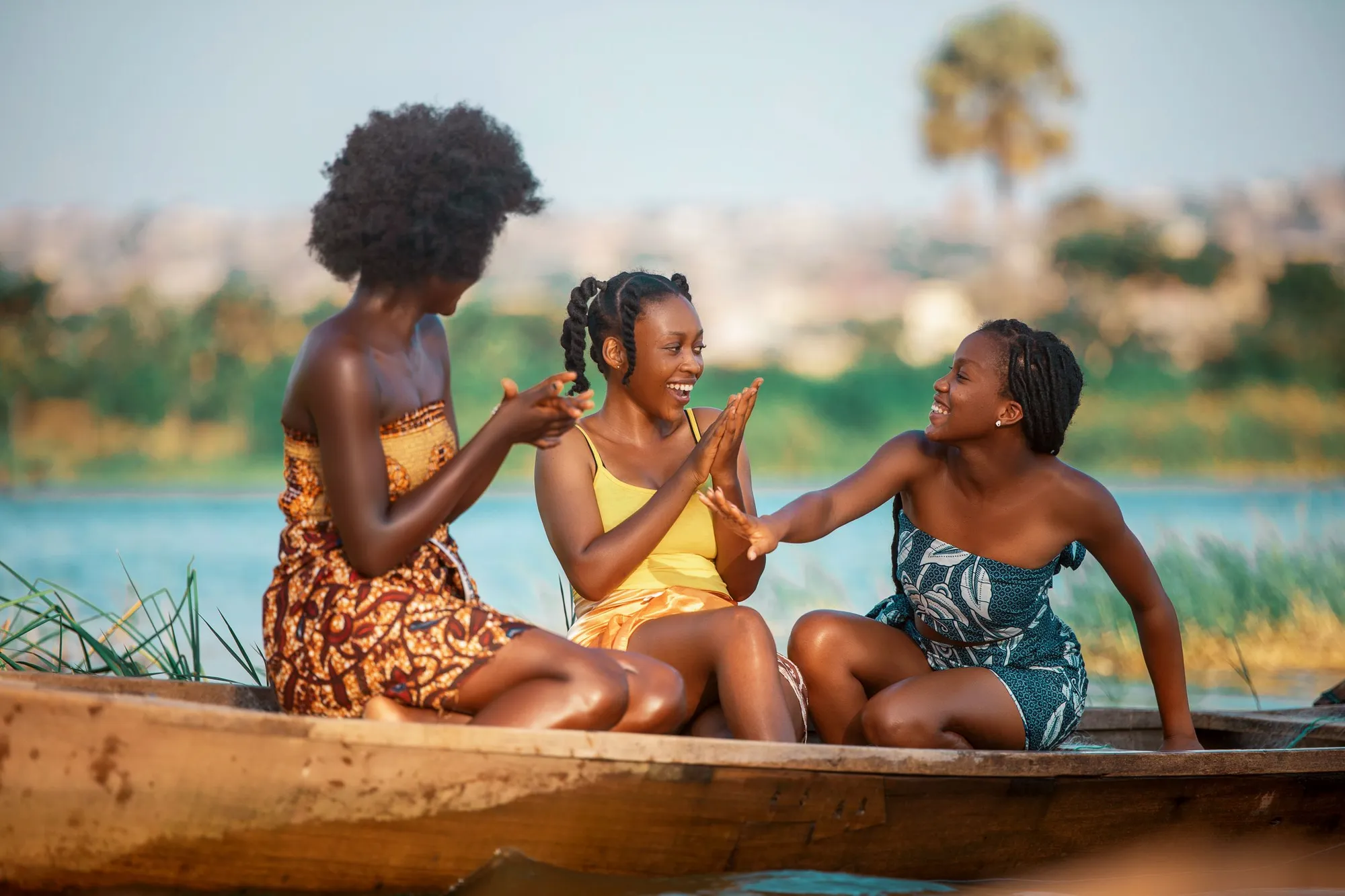 Friends laughing together in a boat on the river